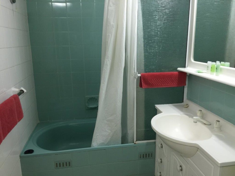 The bathroom is clean and serviceable with a good shower